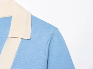 Detail of blue and beige contrast knit collar showing fine texture and sewing craft