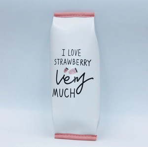 Up-close view of a vertical PU pencil case with strawberry print and pink leather edges