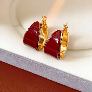 French vintage style gold plated hoop earrings with deep red resin pendant detail