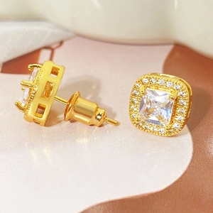 Macro detail of 18k gold plated square stud earrings with halo micro-paved cubic zirconia
