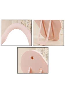 Detail of pink cloud mirror showing foldable stand and wall mounting hole features