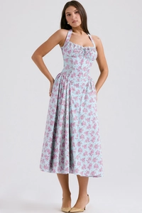 Detail of floral print pattern and halter neck design on a slim fit maxi summer dress