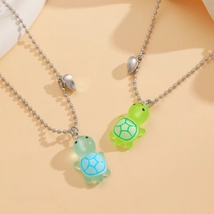 Detail of cute magnetic turtle necklaces with matte resin shell and silver ball chains