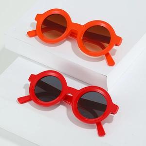 Classic round sunglasses in bright orange and red frames with dark tinted lenses
