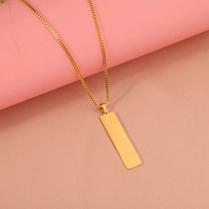 Minimalist gold stainless steel cuboid pendant necklace on a geometric dual-tone background