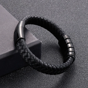 Macro shot of men's black braided leather bracelet with magnetic clasp and metal beads