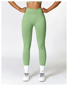 Detailed view of high-waisted seamless sage green yoga pants featuring compression fit