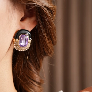 Close-up of vintage enamel square earrings with purple gemstone and rhinestones