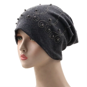 Dark grey slouchy beanie hat in double-layer cotton with silver studded leaf patterns