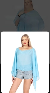 Detail showing elegant light blue semi-transparent shawl with high-quality fabric texture