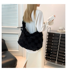 Detail of black and white checkerboard plush tote bag on a model side view