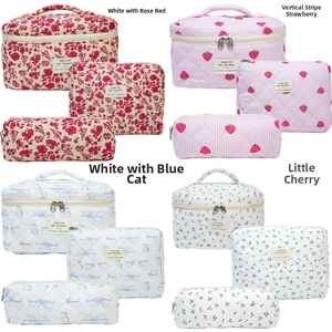 Detailed set of four floral quilted cotton cosmetic bags with zippers in multiple sizes