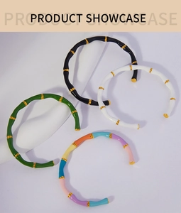 Detailed view of bamboo style open bangles in black, white, green and multicolor enamel