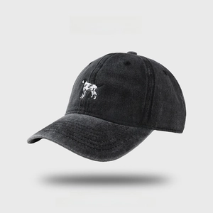 Washed dark gray baseball cap with white dog embroidery and vintage distressed finish