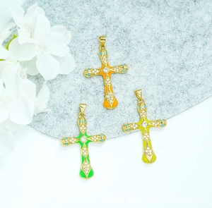 Detail of 18K gold plated cross pendants with colorful enamel and micro-pave crystals