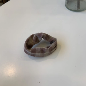 Brown checkerboard knit scrunchie with autumn aesthetic pleats for hair styling