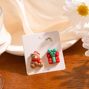 Detailed view of S925 silver Christmas bear and gift box stud earrings on display