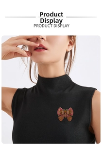 Macro detail of a vintage butterfly brooch with colorful rhinestones on a black coat