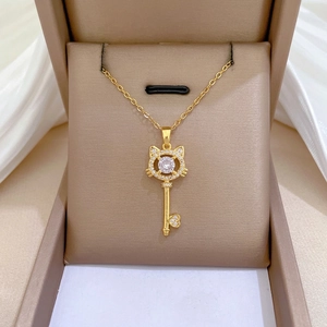 Elegant gold cat-key necklace with zircon rhinestones on pink velvet jewelry box display