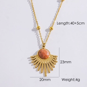 French vintage gold feather necklace with round orange gemstone and sunburst pendant detail
