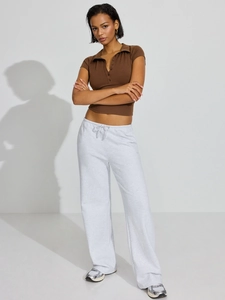 Close-up of brown polo collar buttoned top with drawstring grey joggers for active lifestyle