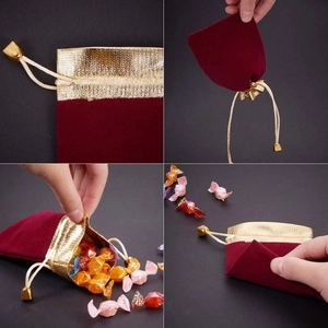 Dark red velvet drawstring jewelry pouch with metallic gold trim and bead closure