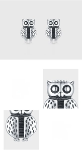 Macro shot of 925 sterling silver owl stud earrings with detailed feather texture