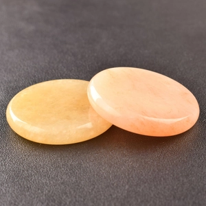 Close-up of circular yellow and pink crystal gemstones with smooth natural textures