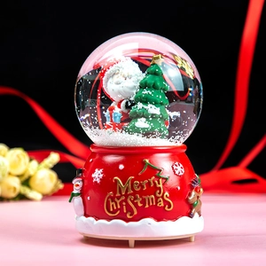 Christmas musical snow globe with Santa Claus, Christmas tree and festive red relief base