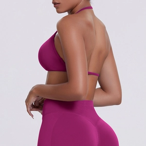 Detail of seamless magenta ribbed fabric on back of halter neck sports bra and leggings