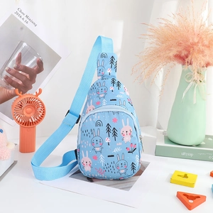Detailed view of kids blue nylon chest bag with cute cartoon rabbit prints and accessories