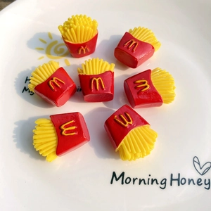 Detail showing 7 miniature resin french fries models with shiny finish for DIY crafts