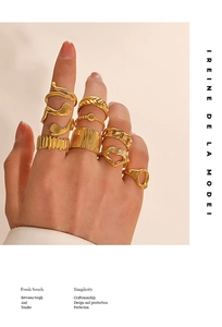 Close-up of stacked 18k gold-plated irregular geometric stainless steel rings on hand