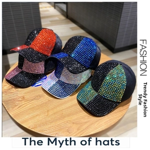 Detail of trendy baseball cap with colorful rhinestones on a wooden tray setting