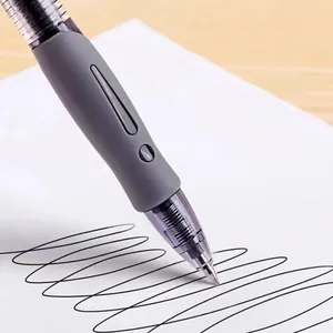 0.5mm retractable gel pen with gray soft grip writing smoothly on white paper