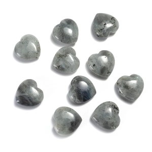 Macro shot of 20mm heart-shaped grey crystal gemstones with smooth polished surface