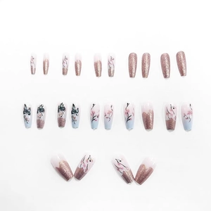 Nail art kit featuring rose gold glitter, black butterfly designs, and pink floral patterns