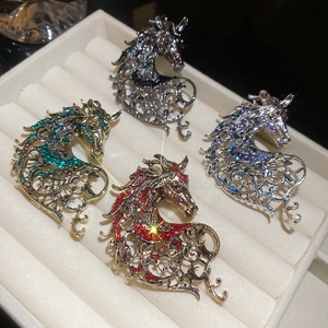 Macro detail of vintage hollow horse brooches with colorful rhinestones in four styles