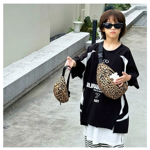 Close-up of children's leopard print canvas chest bag with a stylish pendant for outdoor use