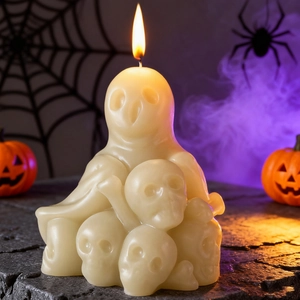 Detailed view of a lit ghost and skull scented candle for Halloween DIY decor