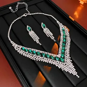 Elegant emerald green drop fringe necklace and earring set with shimmering white crystals