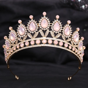 Macro shot of gold wedding tiara with pink crystals and fine white rhinestones