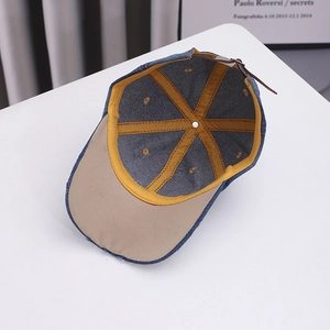 Navy denim baseball cap with yellow inner lining and brown leather adjustable strap