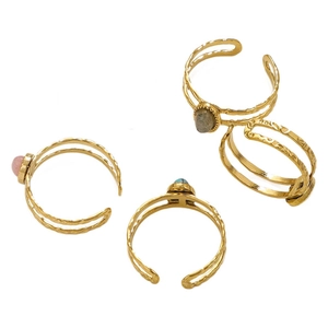Set of four gold stainless steel rings with colorful stones and hammered texture