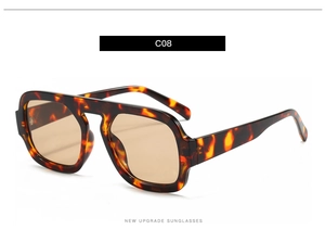 Detail view of tortoiseshell frame and brown lenses of these aviator sunglasses