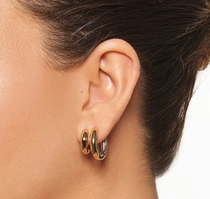 Close-up of elegant gold layered hoop earrings on model highlighting polished finish