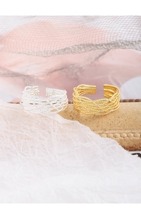 Macro detail of hand-woven lace texture on S925 sterling silver adjustable rings