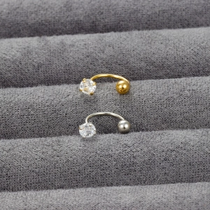 C-shaped cubic zirconia stud earrings in gold and silver finish on velvet display