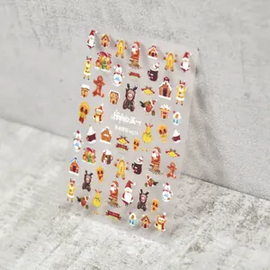 Detail view of Christmas Gingerbread nail art stickers with Santa and reindeer designs