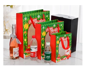 Three sizes of Christmas gift bags with Santa patterns and red ribbon handles